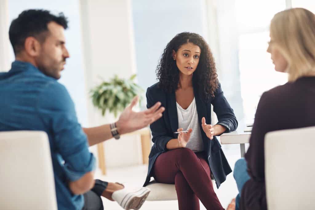 Two people having an argument in front of a mediator