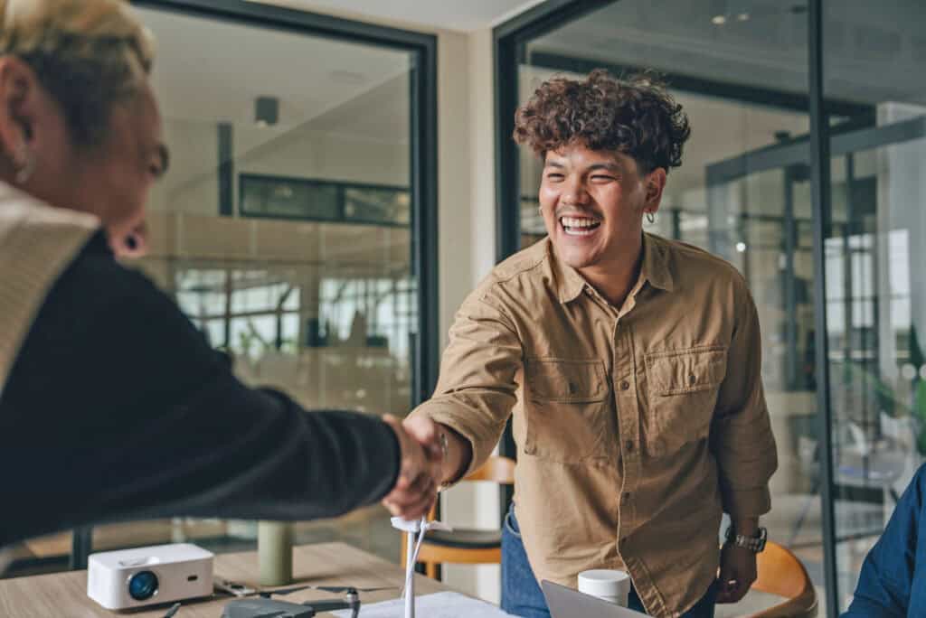 Employee agreeing and shaking hands with a coworker