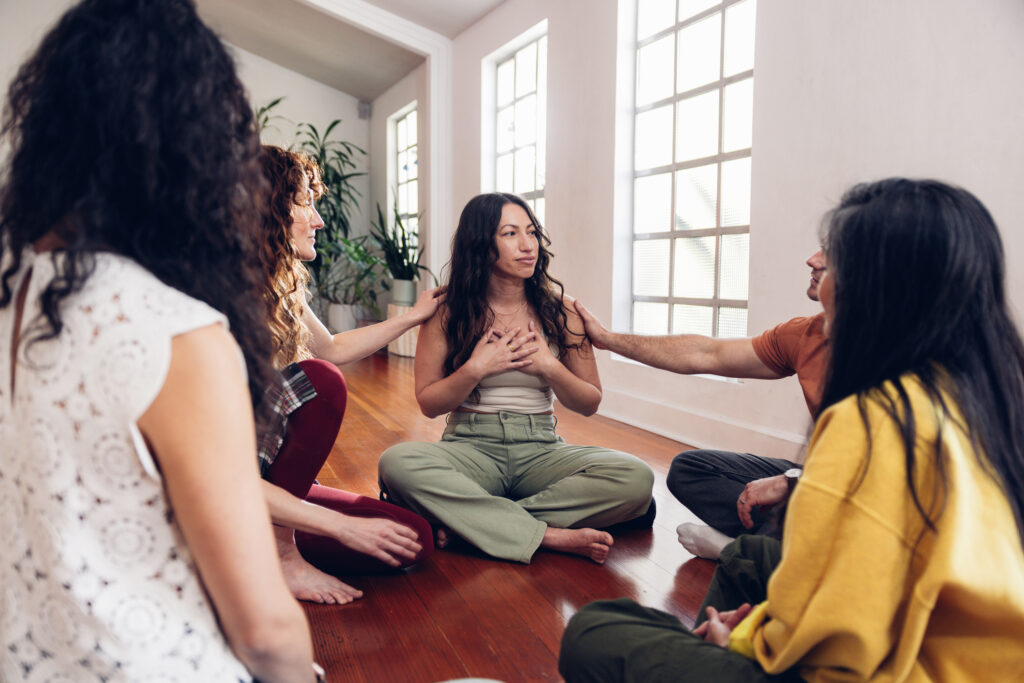 Group of women in a meditation group supporting one of the women who is grieving