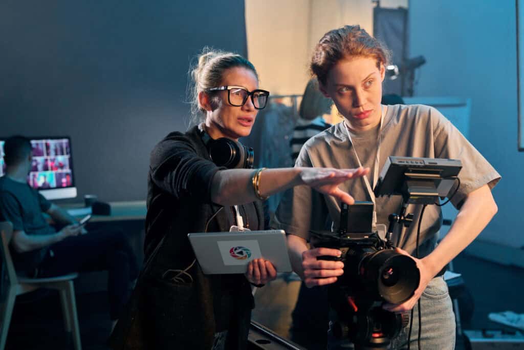 A film director provides guidance to a camera operator