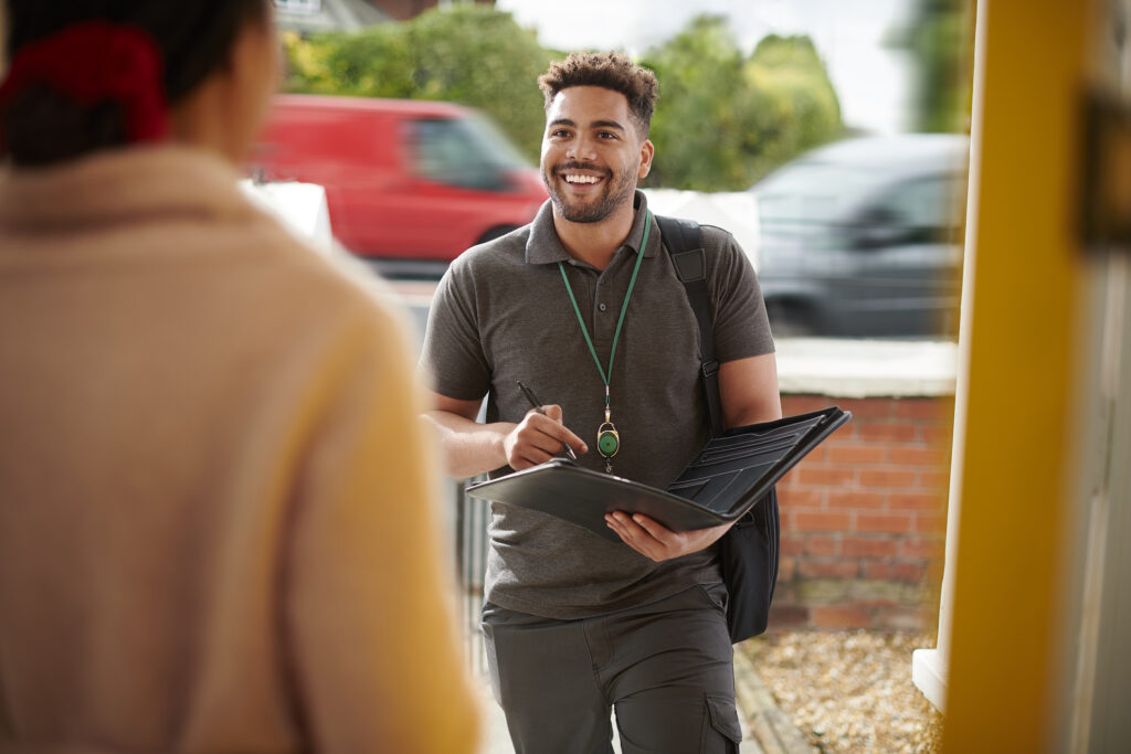 Young social worker arriving at door