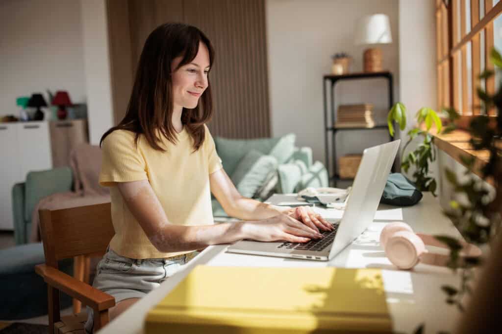 Young social service worker working from home. She looks calm because she is managing her work load well.