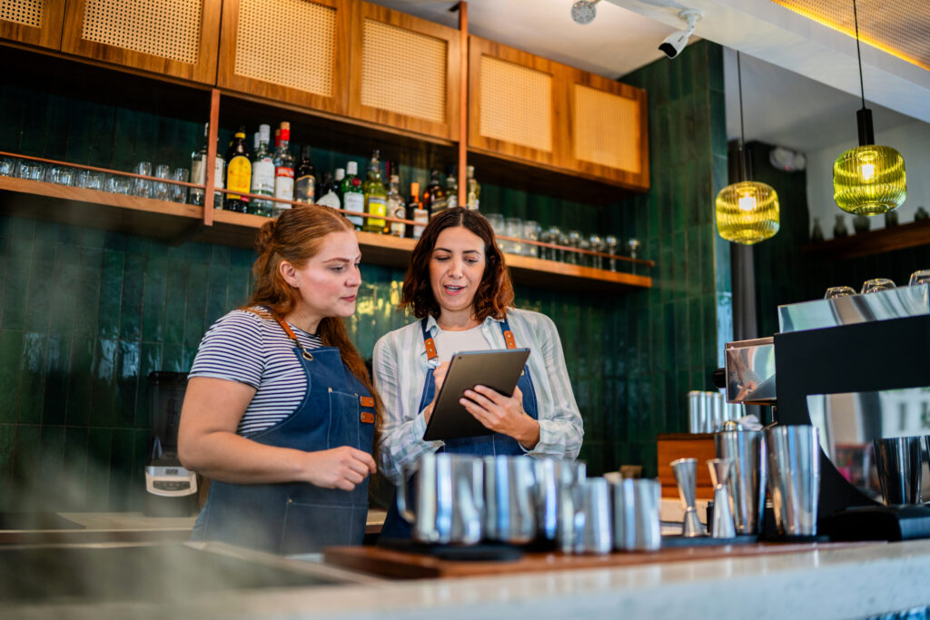 Two restaurant workers talking and planning.