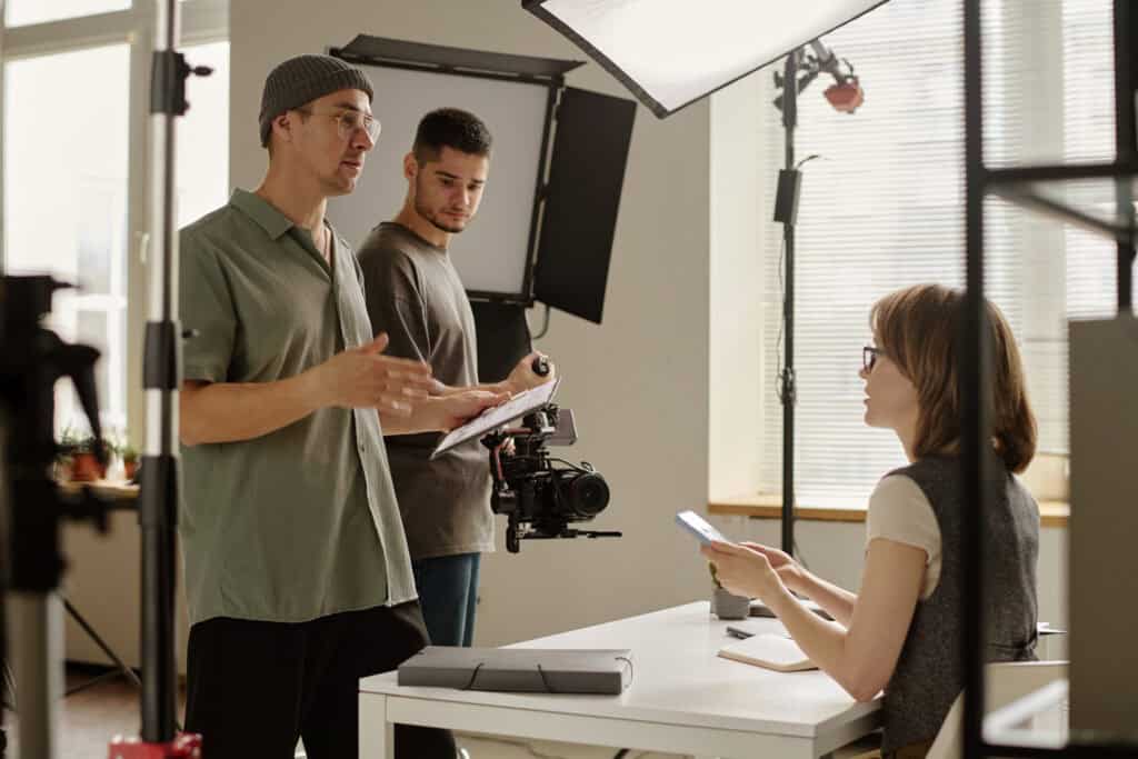Director talking to actor to make sure they are ok. Camera person is standing off to the side.