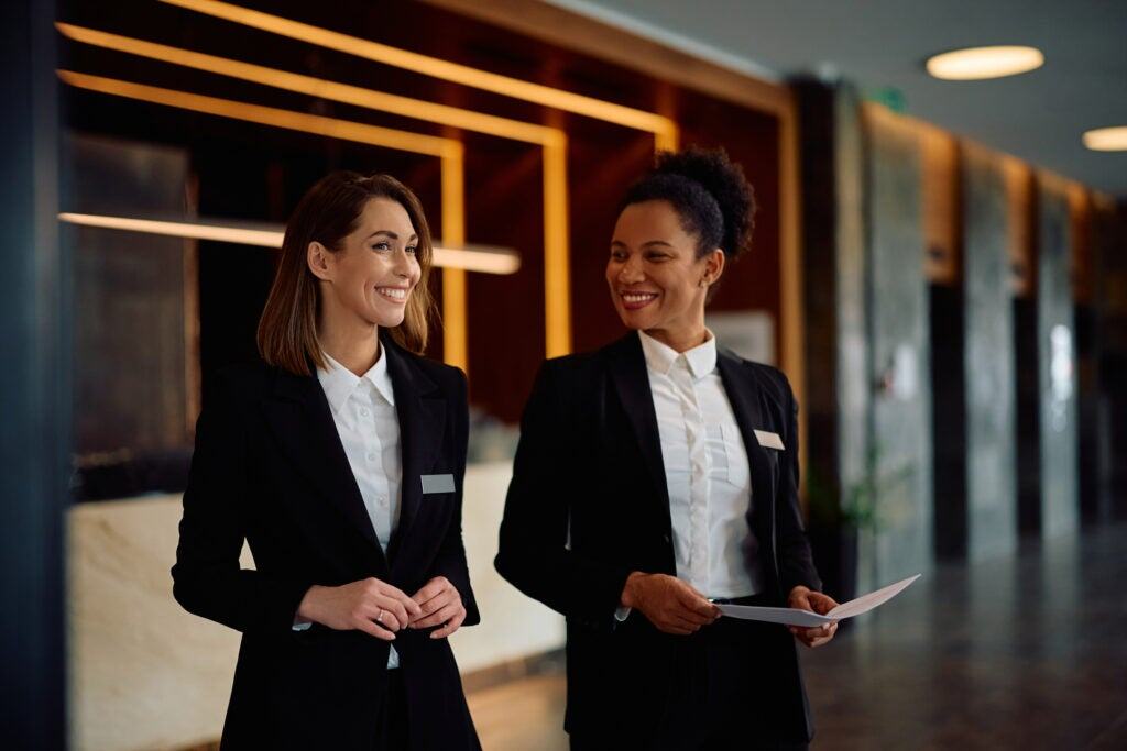 Hotel manager and coworker walking and talking