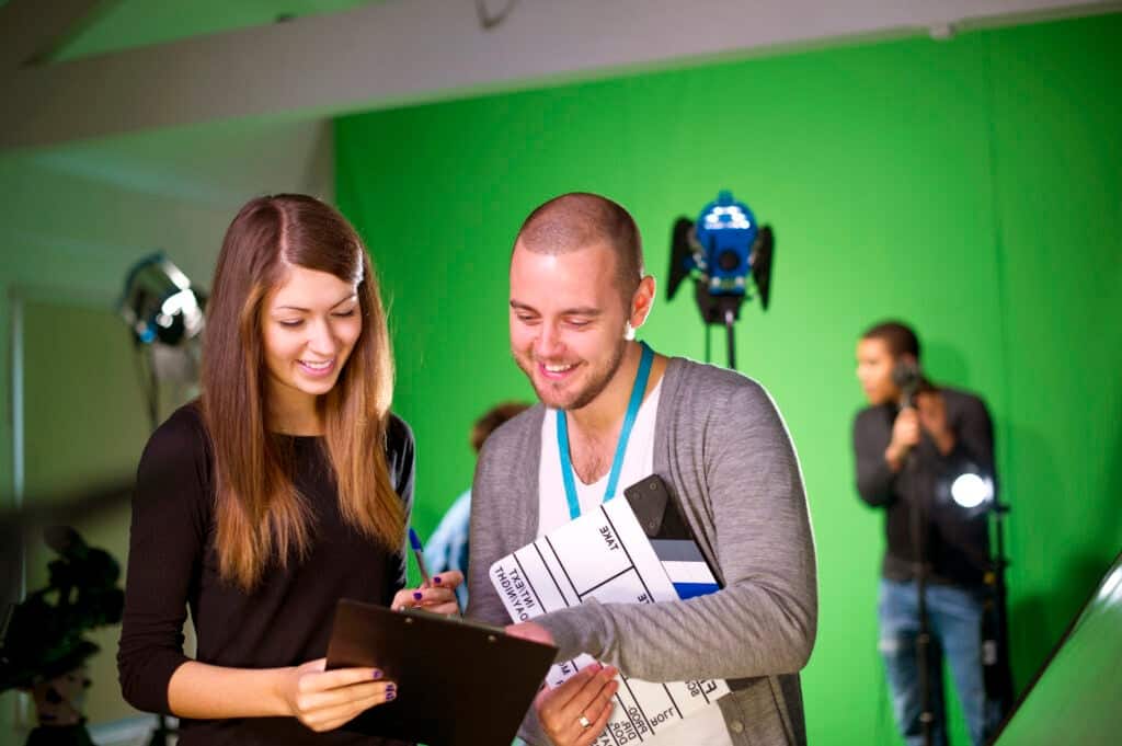 Production staff on a film set having a discussion.