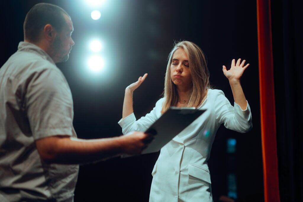 Frustrated actress throwing up her hands in frustration