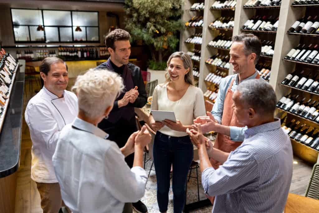 Restaurant manager having a pep talk with her team