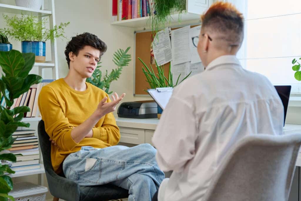 Young man talking to counsellor.