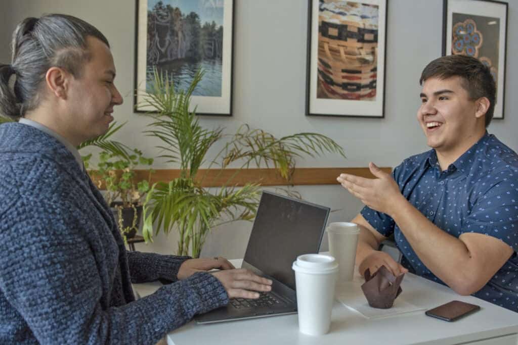 Young Indigenous man talking clearly and having a disagreement with a friend.