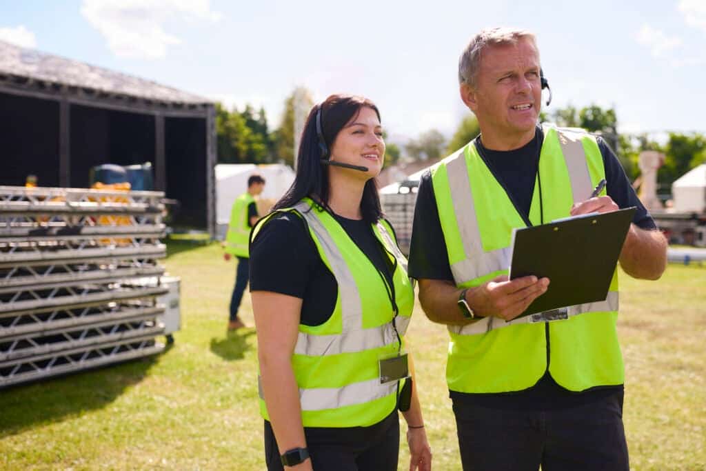 Two film production crew members discussing plans.