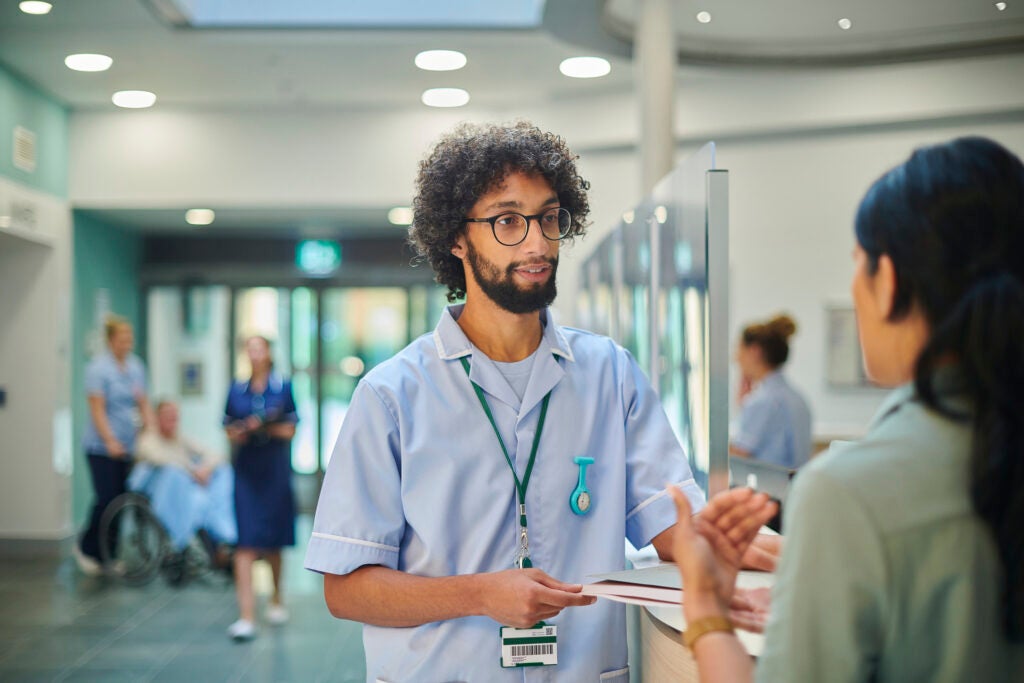 Male nurse listening to patient