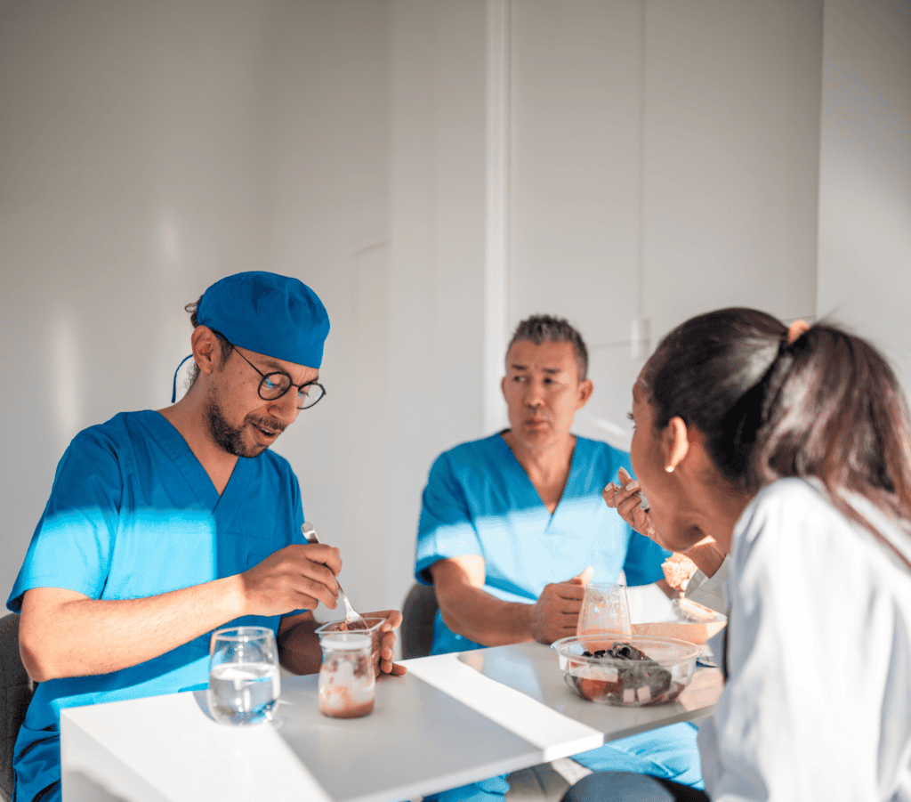 Male nurse having lunch with his colleagues