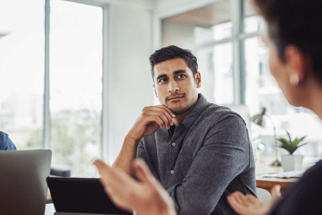 Concerned worker listens to other worker talking about concerns.