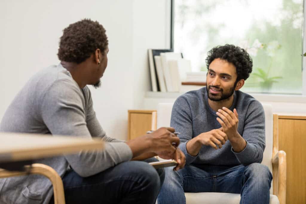 Male counsellor talking to male client
